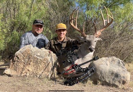 Cade Thomas (right) shows off his personal best buck that he harvested with stick and string in Kinney County, Texas, with his dad, Bobby Thomas.