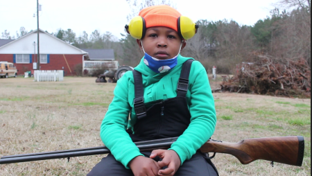 Eight-year-old LJ poses with a 20-gauge shotgun and loves to talk about why he loves hunting.