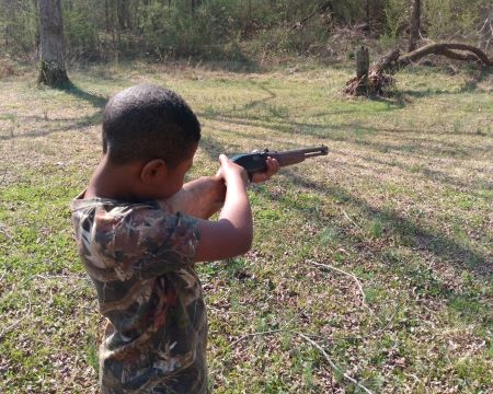 At 7 years old, LJ was learning to shoot a .22 rifle.