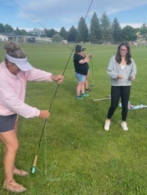 Lilli showing her physics teacher how to assemble a fly rod.